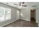 Bright living room with gray walls, hardwood floors, and a white door at 7133 Pineview Sw Dr, Covington, GA 30014
