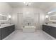 Elegant bathroom with double vanities, a freestanding tub, and marble floors at 1782 Patrick Rd, Dacula, GA 30019