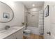 Clean bathroom with white vanity, bathtub, and gray tile shower at 1782 Patrick Rd, Dacula, GA 30019