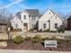 Two-story home with white brick, gray shutters, and landscaping at 1782 Patrick Rd, Dacula, GA 30019