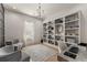 Spacious home office with built-in shelving and hardwood floors at 1782 Patrick Rd, Dacula, GA 30019