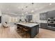 Modern kitchen with large island, stainless steel appliances, and gray cabinets at 1782 Patrick Rd, Dacula, GA 30019