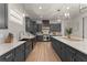 Modern kitchen with gray cabinetry, quartz countertops, and a farmhouse sink at 1782 Patrick Rd, Dacula, GA 30019