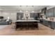 Modern kitchen with gray cabinets, large island, and stainless steel appliances at 1782 Patrick Rd, Dacula, GA 30019