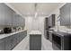 Bright laundry room with gray cabinets and plenty of counter space at 1782 Patrick Rd, Dacula, GA 30019