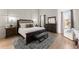 Spacious main bedroom with plush bed, large dresser, and wood floors at 1782 Patrick Rd, Dacula, GA 30019