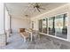 Covered patio with a dining table, ceiling fans, and sliding glass doors at 1782 Patrick Rd, Dacula, GA 30019