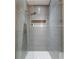 Walk-in shower with gray wave tile and glass enclosure at 1782 Patrick Rd, Dacula, GA 30019