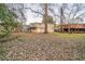 Wide shot of a grassy backyard with a fence and mature trees at 3401 Tulip Dr, Decatur, GA 30032