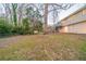 A large backyard with trees and a glimpse of the house at 3401 Tulip Dr, Decatur, GA 30032
