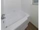 Bright white bathtub with chrome hardware and tiled walls at 3401 Tulip Dr, Decatur, GA 30032