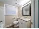 Bathroom with white vanity, granite countertop, and decorative framed mirror at 3401 Tulip Dr, Decatur, GA 30032