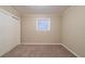 Bedroom with neutral walls and carpet, features a bright window and closet at 3401 Tulip Dr, Decatur, GA 30032