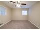 Neutral bedroom with carpet, bright ceiling fan, and lots of natural light from two windows at 3401 Tulip Dr, Decatur, GA 30032