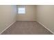 Small bedroom with neutral walls and carpet, and bright window at 3401 Tulip Dr, Decatur, GA 30032