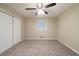 Neutral bedroom with carpet, a double door closet, and bright ceiling fan and window at 3401 Tulip Dr, Decatur, GA 30032
