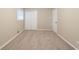 Bedroom with neutral walls and plush carpet, features double door closet and bright window at 3401 Tulip Dr, Decatur, GA 30032