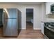 View of kitchen with stainless steel refrigerator, stove, and granite countertops at 3401 Tulip Dr, Decatur, GA 30032