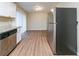 Open kitchen showcasing stainless steel fridge and views to the dining area at 3401 Tulip Dr, Decatur, GA 30032