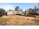 Large backyard with mature trees and a home at 4822 Tomahawk Sw Ct, Lilburn, GA 30047