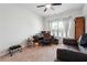 Well-lit home office with a desk, couch, and built-in shelving at 5857 Silver Lake Dr, Mableton, GA 30126