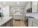 Modern kitchen with gray cabinets, granite counters, and stainless steel appliances at 5857 Silver Lake Dr, Mableton, GA 30126