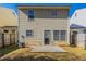 The back of the home has a concrete patio and a door, and is surrounded by a wooden fence at 128 Prity Ct, Mcdonough, GA 30253