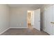 Bedroom with neutral walls, carpet, and a view into the Laundry Room at 128 Prity Ct, Mcdonough, GA 30253