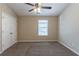 Bedroom featuring neutral walls, carpet, ceiling fan, and a double-door closet at 128 Prity Ct, Mcdonough, GA 30253