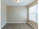 Bright bedroom featuring neutral walls, modern wood-look flooring and a window at 128 Prity Ct, Mcdonough, GA 30253
