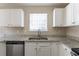 Kitchen featuring stainless steel appliances, granite countertops, a double sink and white cabinets at 128 Prity Ct, Mcdonough, GA 30253