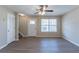 Living room featuring a decorative ceiling fan, front door and large windows for natural light at 128 Prity Ct, Mcdonough, GA 30253