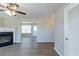 Living room featuring a decorative ceiling fan, fireplace, and entry into dining area at 128 Prity Ct, Mcdonough, GA 30253