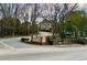 A community entrance sign surrounded by a lush landscape and tall bare trees during winter at 5 Belmonte Sw Ct, Atlanta, GA 30311
