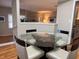 Light streams into this dining area with hardwood floors and a glass table at 5 Belmonte Sw Ct, Atlanta, GA 30311