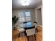 Bright dining room features wood floors, natural light, a glass table and comfortable seating at 5 Belmonte Sw Ct, Atlanta, GA 30311