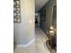 Hallway featuring stylish neutral walls, tiling, a decorative mirror, and a gold table at 5 Belmonte Sw Ct, Atlanta, GA 30311