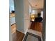 Hallway leading to a hardwood-floored living room and a kitchen featuring white cabinetry at 5 Belmonte Sw Ct, Atlanta, GA 30311