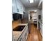 A modern kitchen featuring white cabinets, a stainless steel fridge, and hardwood floors at 5 Belmonte Sw Ct, Atlanta, GA 30311