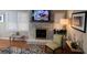 Charming living room featuring a brick fireplace, mounted TV, and plenty of natural light at 5 Belmonte Sw Ct, Atlanta, GA 30311