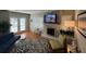 Cozy living room with a fireplace, mounted TV, and lots of natural light from French doors and windows at 5 Belmonte Sw Ct, Atlanta, GA 30311
