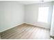 Simple bedroom with large window and wood floors at 4126 Mcbride Dr, Powder Springs, GA 30127