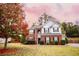 Two-story brick home with gray siding, landscaped lawn, and attached garage at 4126 Mcbride Dr, Powder Springs, GA 30127