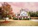 Two-story brick home with gray siding, landscaped lawn, and attached garage at 4126 Mcbride Dr, Powder Springs, GA 30127