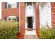 Inviting front entrance with brick columns and a black door at 4126 Mcbride Dr, Powder Springs, GA 30127