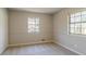 Bedroom with carpet, neutral walls, and two windows at 8652 Embrey Dr, Jonesboro, GA 30236