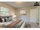 Virtually staged bedroom with large bed and neutral decor at 8652 Embrey Dr, Jonesboro, GA 30236