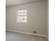 Simple bedroom with carpet, single window and neutral walls at 8652 Embrey Dr, Jonesboro, GA 30236