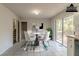 Virtually staged dining area with sliding glass doors to deck at 8652 Embrey Dr, Jonesboro, GA 30236