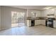 Kitchen features white cabinets, black appliances, and tile floor at 8652 Embrey Dr, Jonesboro, GA 30236